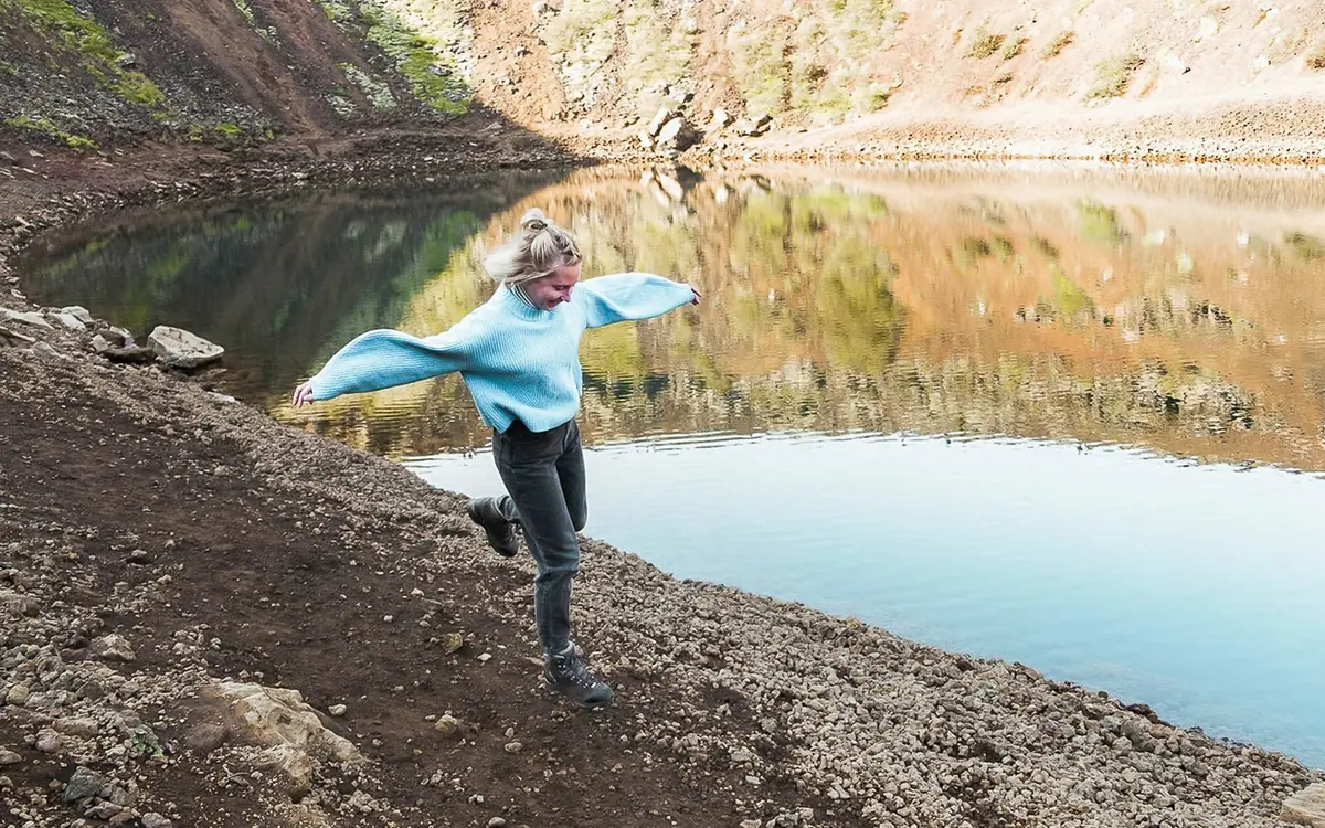 The red rim and green water of Kerið volcanic crater lake