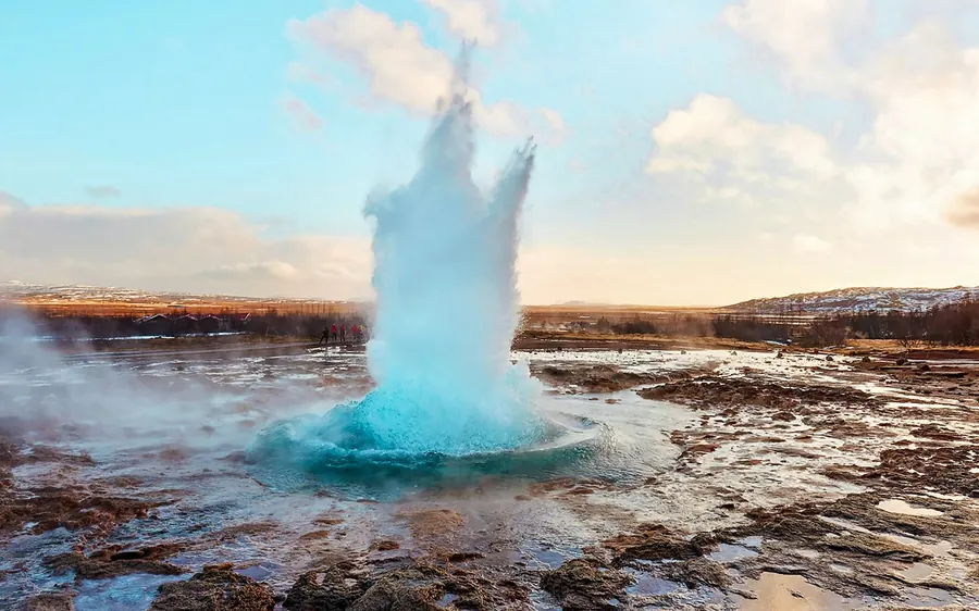Strokkur geyser building a blue dome of water before it erupts