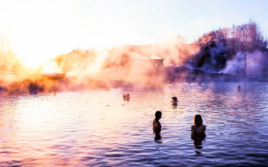 The Secret Lagoon geothermal pool steaming at sunset
